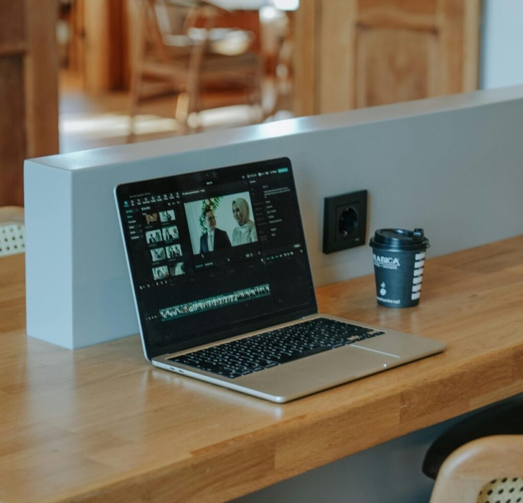 Modern workspace with laptop and coffee in a stylish home office setup.